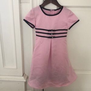 Girl’s pink dress with black trim